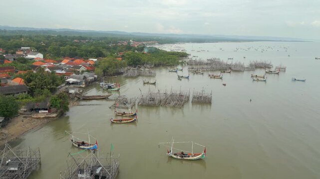 Galis Fishing Village Madura Island Indonesia Bamboo Ocean Huts Drone Track Overhead 4K 60FPS