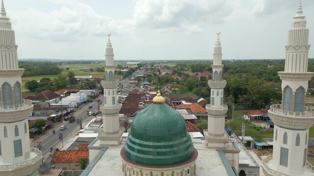 Minarets On Green Muslim Mosque Madura Island Indonesia Drone Track Back 4K 60FPS