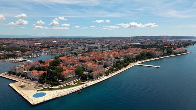 Historic old town peninsula of Zadar with red tiled roofs on a sunny day, Croatia.Sea Organ aerial view
