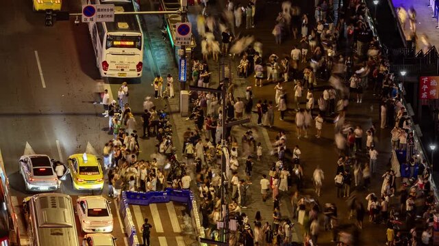  street busy with people and traffic next to hongyadong cave in chongqing