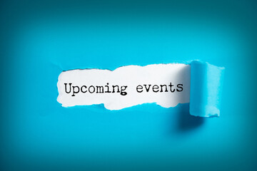 Upcoming events chalkboard sign on wooden desk © ARAMYAN