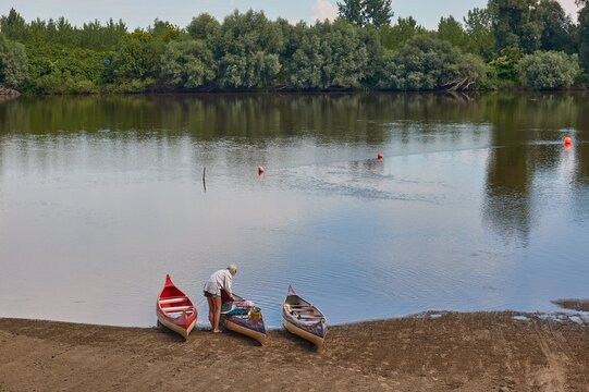 Canoes on the Riverside, people loading packs