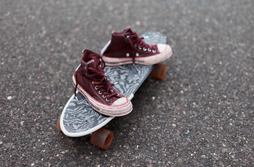 Used canvas shoes on skateboard © goir