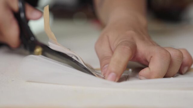 Precision cutting fabric with dressmaking shears for custom wedding gown construction