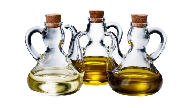 Isolated three glass cruets with corks containing different shades of cooking oils
