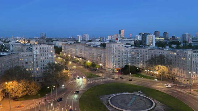 Urban cityscape evening: Aerial view of the roundabout at Strausberger Platz in Berlin on Karl-Marx with clam traffic and a view of the capital to the east
