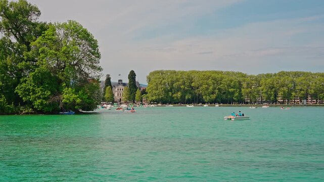 Lake Annecy Emerald Water with Pedal Boats and Lakeside Park.Captured on April 29, 2026.