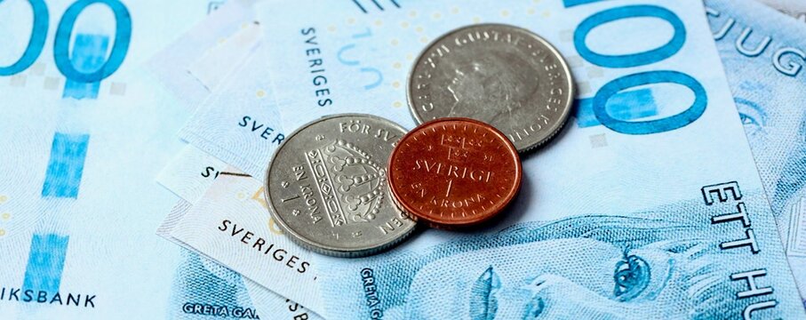 Swedish krona money bills and coins on table. Sweden cash of SEK currency close up