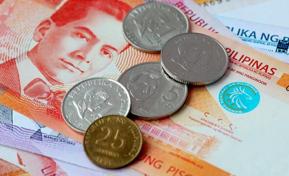 Philippine peso money bills and coins on table. Philippines cash of PHP currency close up