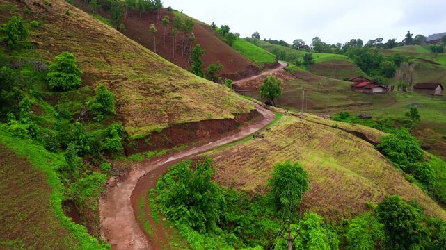 Scenic Aerial View of Monsoon Hilly Jungle with U Shape Road Passing Through Dense Green Forest, Misty Mountains, Rainy Weather, Lush Vegetation, Mountain Landscape and Beautiful Natural Countryside S