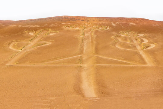 Ancient Paracas Candelabra geoglyph carved into the desert hillside overlooking the Pacific coast near the Ballestas Islands in Peru