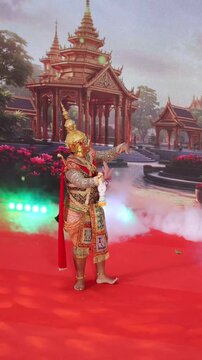 Thotsakan demon king with a golden mask holding a garland and dancing in a traditional Thai Khon