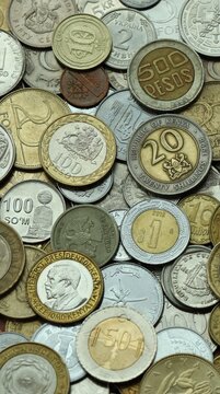 Large amount of different coins from various money currencies. Treasure and numismatics concept