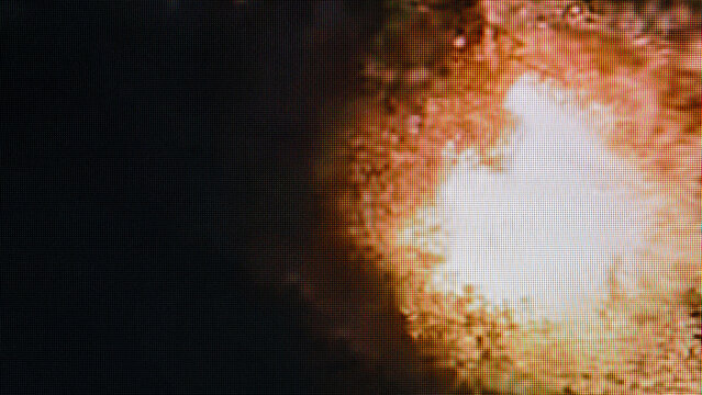Abstract fire explosion pixels on dark screen
