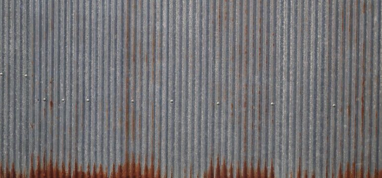 Slightly rusted zinc sheet texture with weathered industrial surface and details.