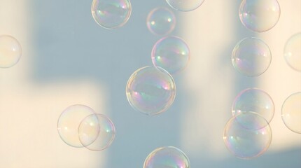 Fototapeta premium Transparent iridescent soap bubbles floating in the air against a soft blurred background with natural sunlight and pastel colors creating a dreamlike atmosphere