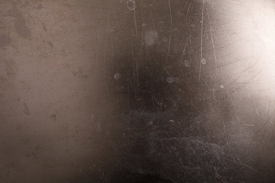 Close up of a scratched and smudged metallic background texture.