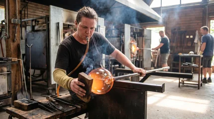 Glassblower Shaping Molten Glass with Pipe and Tool in Workshop © GeniusMinus