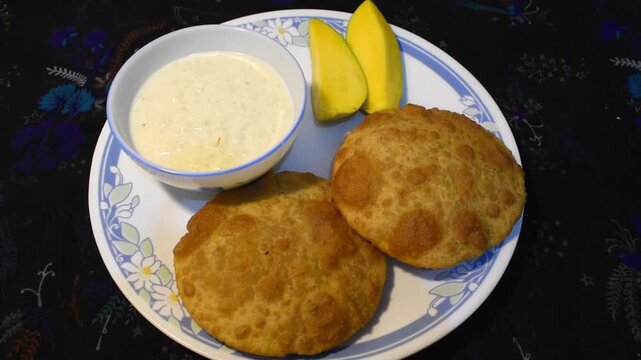 Ardra special traditional bihari thali featuring dal puri, rice kheer, ripe mango, and mixed vegetable curry
