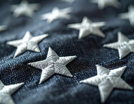 A close-up shot of embroidered white stars on a dark blue fabric.