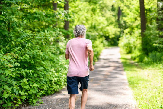 Nice active 70s senior men runner or fast walk in a park