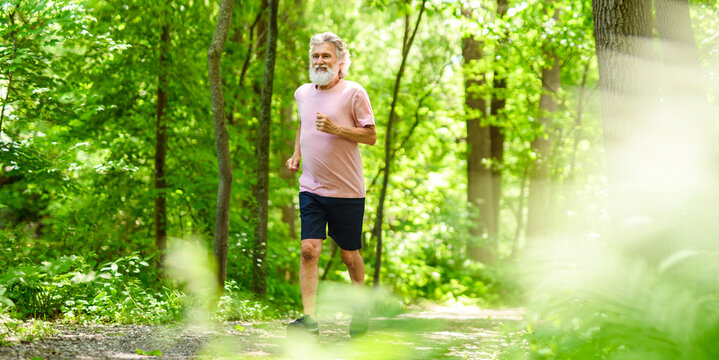 Nice active 70s senior men runner or fast walk in a park