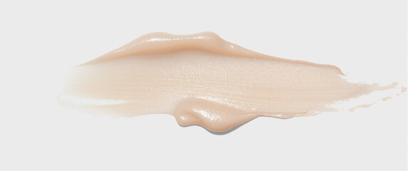 Fototapeta premium Beige foundation cream smear on a white background