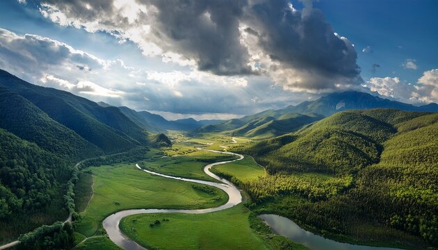 Serene Aerial View Of A Lush Green Valley With A Winding River And Dramatic Mountains Under A Clou