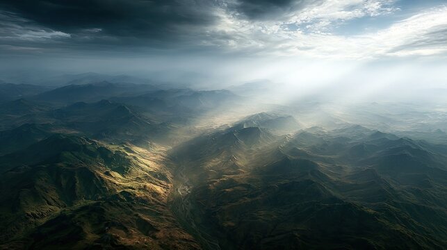 Dramatic sunbeams pierce stormy clouds over rugged, textured mountain landscape