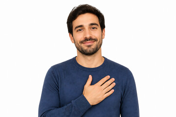 Fototapeta premium A smiling man in a blue sweater is posing against a white background, holding his hand over his chest.
