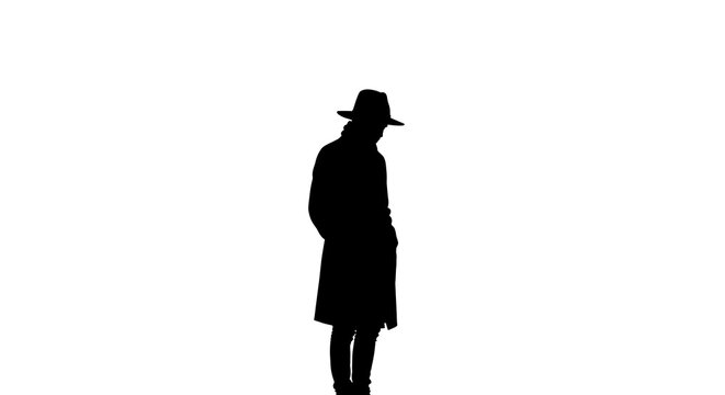 Silhouette of a man wearing a trench coat and fedora hat isolated on white background.