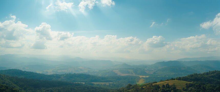 Luminous blue sky enhancing a serene summer landscape with white cloud formations