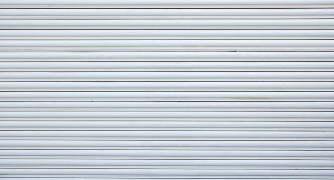 White metal roller door shutter texture background with smooth panel surface