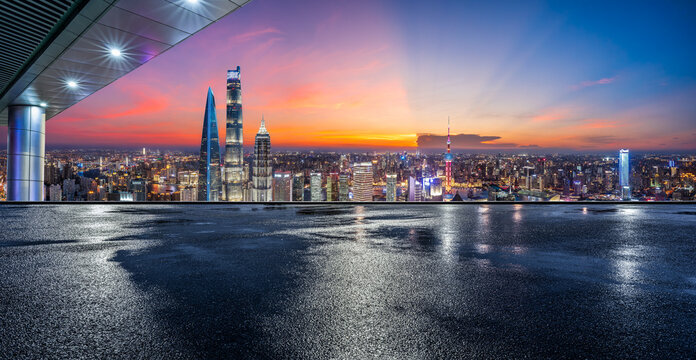 Night view of Shanghai skyline with skyscrapers and wet asphalt ground in China