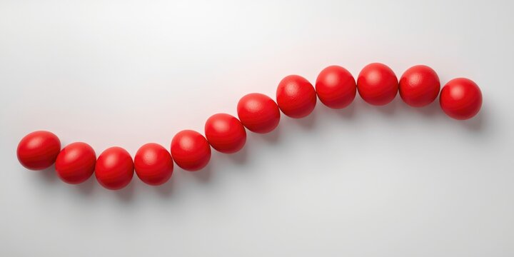 Sequence of radiant red eggs placed on a plain white backdrop offering ample copy space