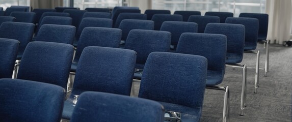 Fototapeta premium Lineup of contemporary blue chairs arranged for a meeting space