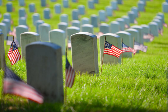 Arlington National Cemetery - Headstones and U.S. National flags - Circa Washington D.C. United States of America