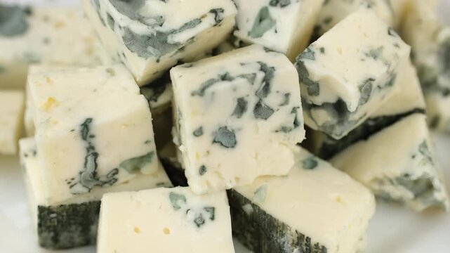 Fresh Blue cheese. Heap of sliced blue cheeses with a noble mold, rotate