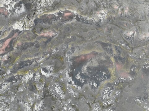 Aerial view of the volcanic landscape of Krakatindur with dark lava rock, patches of green moss, and rugged terrain in Kirkjubaejarklaustur, Skaftarhreppur, Iceland.