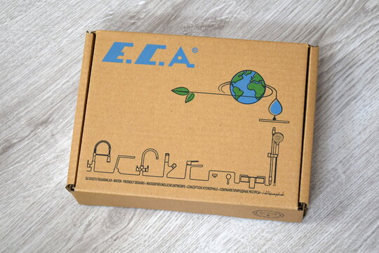 A closed cardboard product box of the Turkish plumbing brand E.C.A. with a blue logo, eco-friendly earth illustration, and line icons of faucets. 