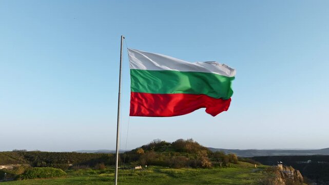 Bulgarian flag waving wind close up Ovech fortress mountain background national symbol tricolor white green red pride patriotism bulgaria holiday editorial graphic commercial design template