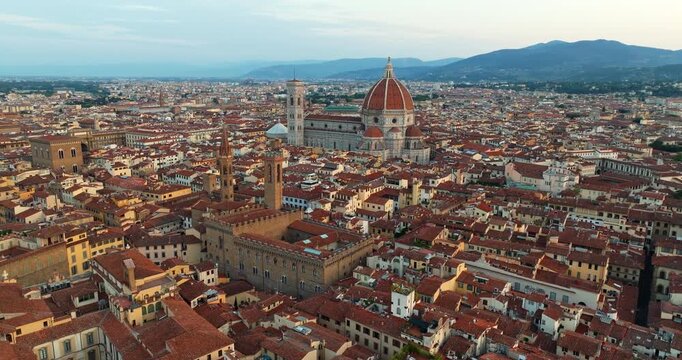 Florence cityscape aerial view Santa Maria del Fiore cathedral Italy medieval town sunrise drone shot terrace roof red tile pattern landscape travel tourism commercial destination background poster
