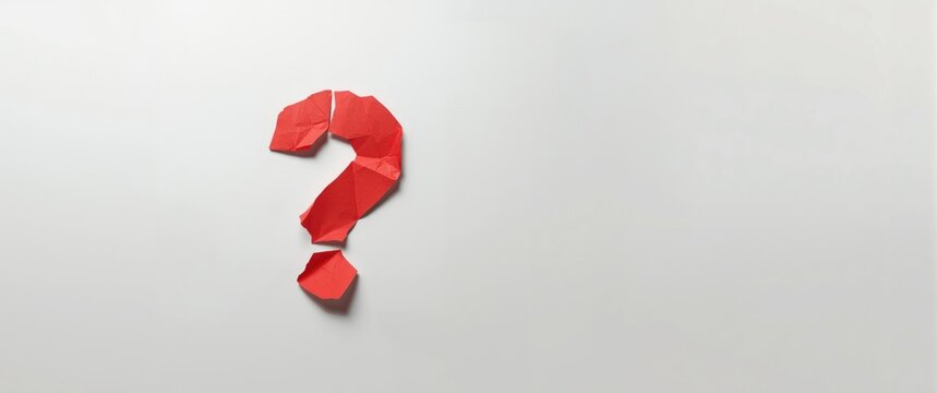 Red paper question mark on a white background