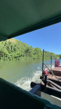 21 October 2024, USA, Hawaii, The Garden Isle, Kauaʻi, Kapaa, Wailua River - timelapse fern grotto tourist boat tour overlooking riverbank