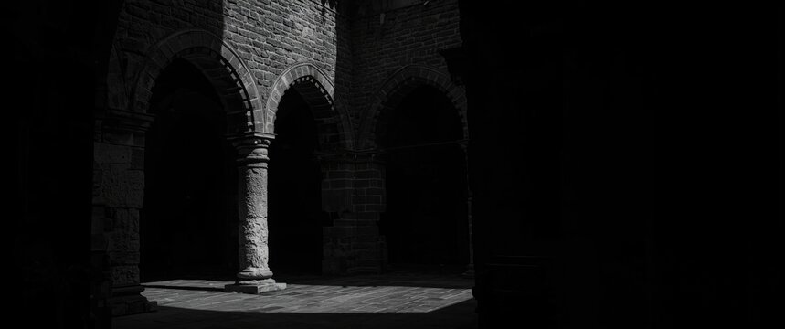 Gothic arches casting shadows in a dim interior space