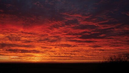 Fototapeta premium Vibrant sunset with dramatic red and orange clouds