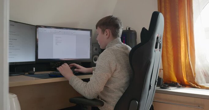 Kid Boy Use Desktop Computer for Study Typing and Reading. 4K 10-bit