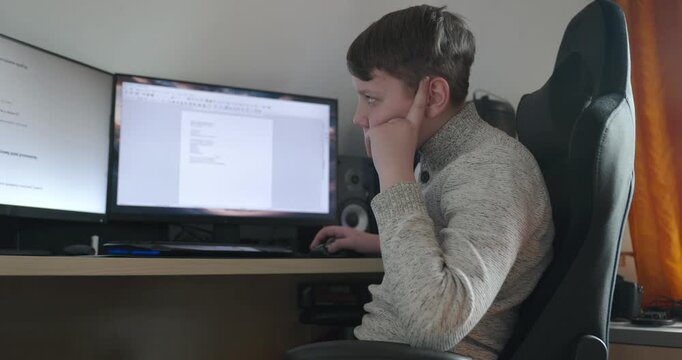 Kid Boy Use Desktop Computer for Study Typing and Reading. 4K 10-bit