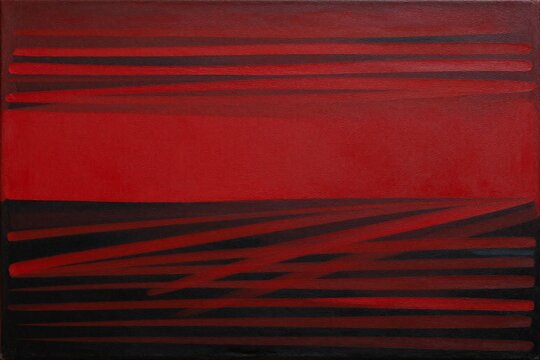 A close up of a red and black painting on a wall
