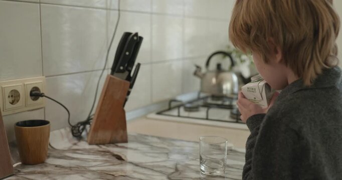 Kid Boy Drink Milk in Kitchen. 4K 10-bit